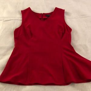 Red asymmetric sleeveless blouse.